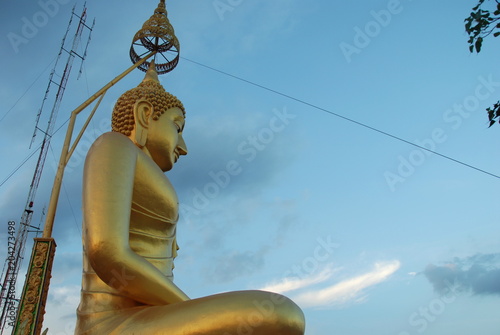Big Buddha golden statue on the top of mountain by Tiger Cave, Krabi, Thailand photo