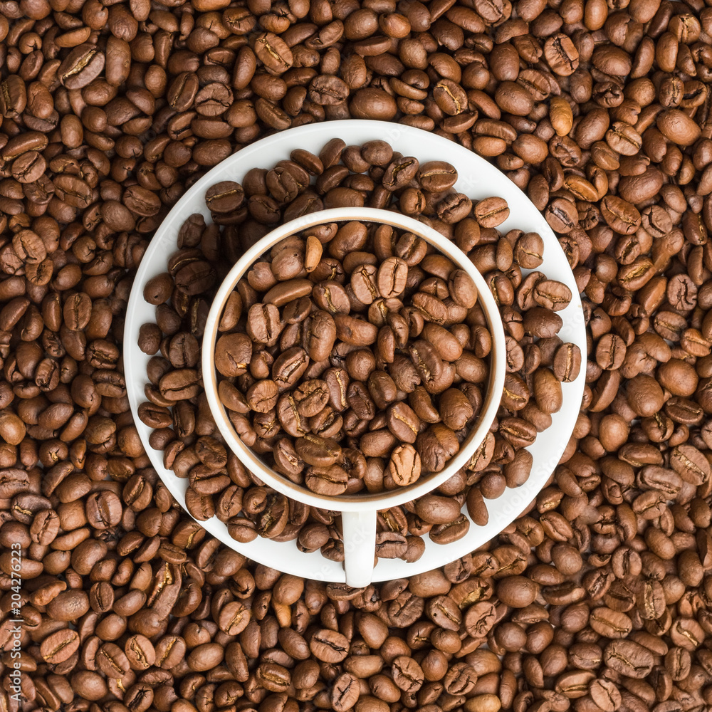 Fototapeta premium The coffee cup and saucer are filled with coffee grains and resemble the computer's power button