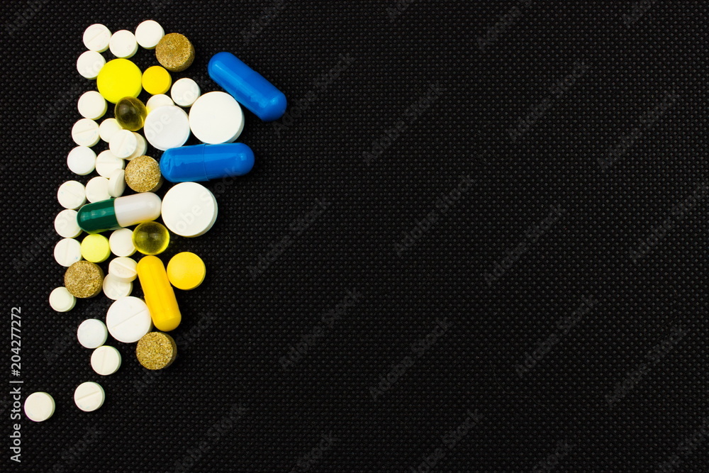 Capsules and tablets on plastic spoon. Medicine pharmaceutical theme. Free space for text