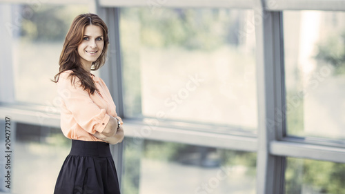 portrait of successful business woman near a large window in a modern office