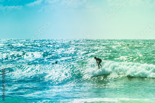 Surfers riding some waves on the sea