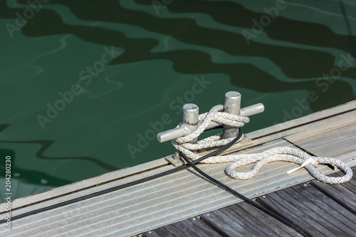 Mooring rope tied around a cleat © dvoevnore