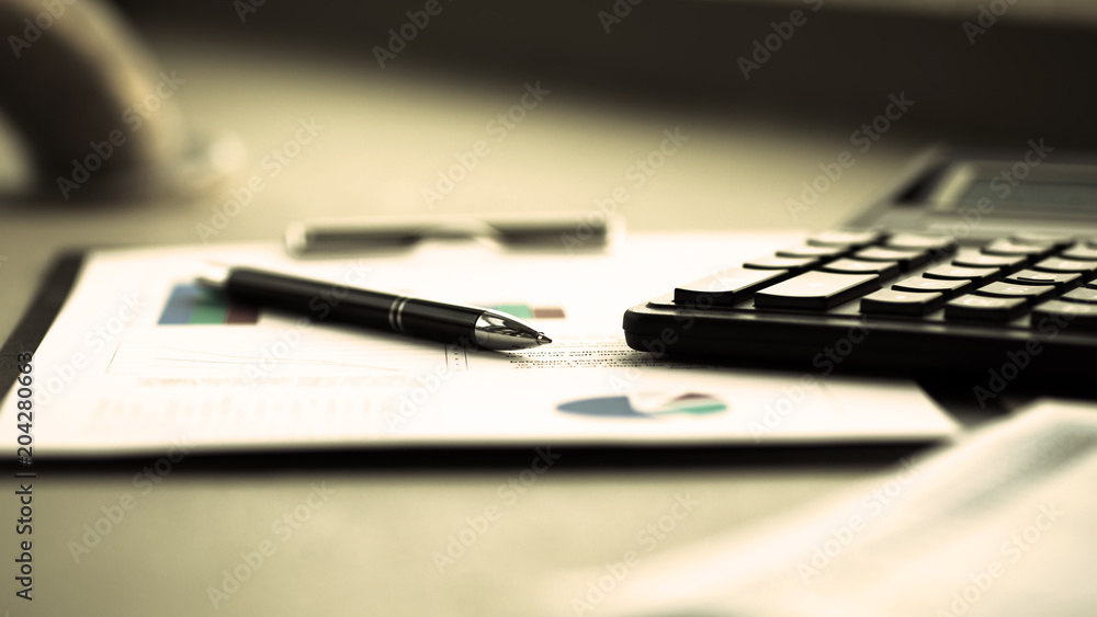 Business financial analysis of the workplace with a calculator and documents in the office Business financial analysis of the workplace with a calculator and documents in the office