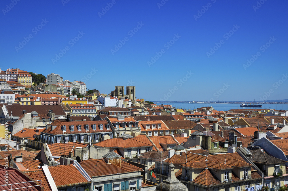 Beautiful view of the city of Lisbon, with the skyline and the Lisbon Cathedral and the Tagus River on the background; Concept for travel in Lisbon
