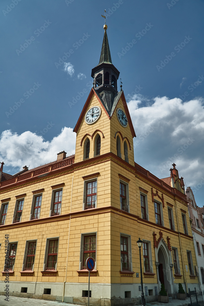 historic town hall with a clock tower on the market square in the city of Vidnava in the Czech Republic.