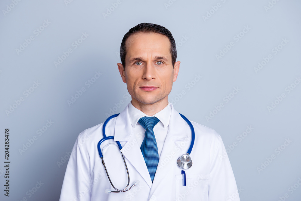 Close up portrait of authoritative professional successful serious smart intelligent clever with wrinkles doctor holding light blue stethoscope on shoulders isolated on gray background Close up portrait of authoritative professional successful serious smart intelligent clever with wrinkles doctor holding light blue stethoscope on shoulders isolated on gray background