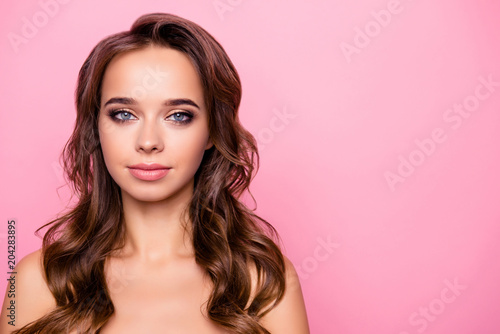 Portrait with copy space, empty place for advertisement, product of shine, charming, attractive, adorable, sexy girl with curly hair, looking at camera isolated on pink background