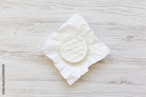 Camembert on white wooden background. Food for wine. Flatlay. Top view.