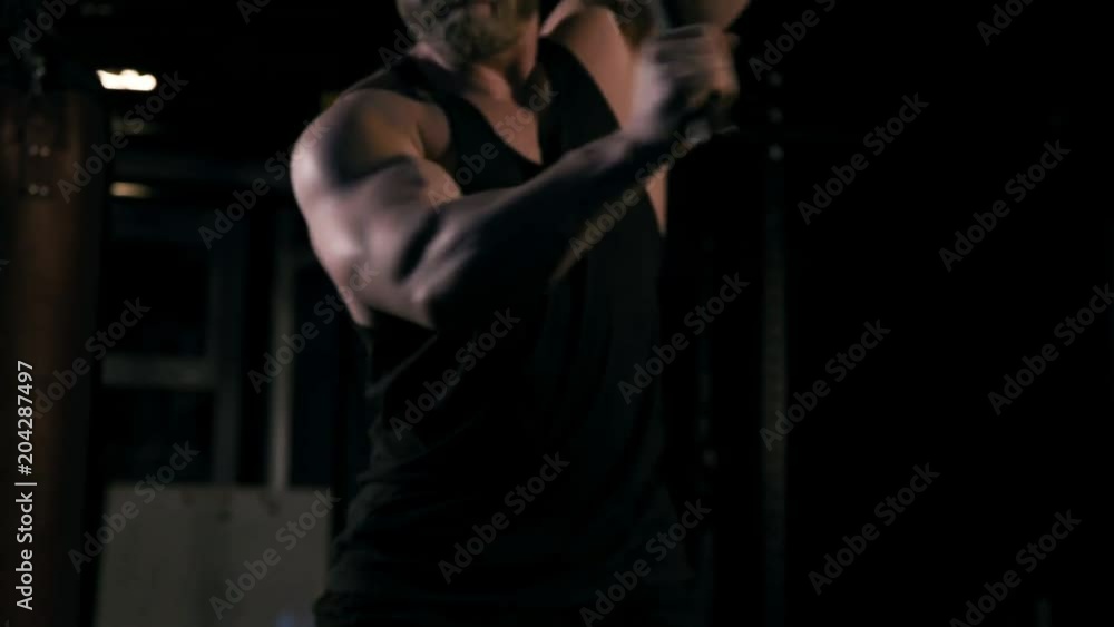 Strong man in training with a hammer and wheel Strong man in training with a hammer and wheel