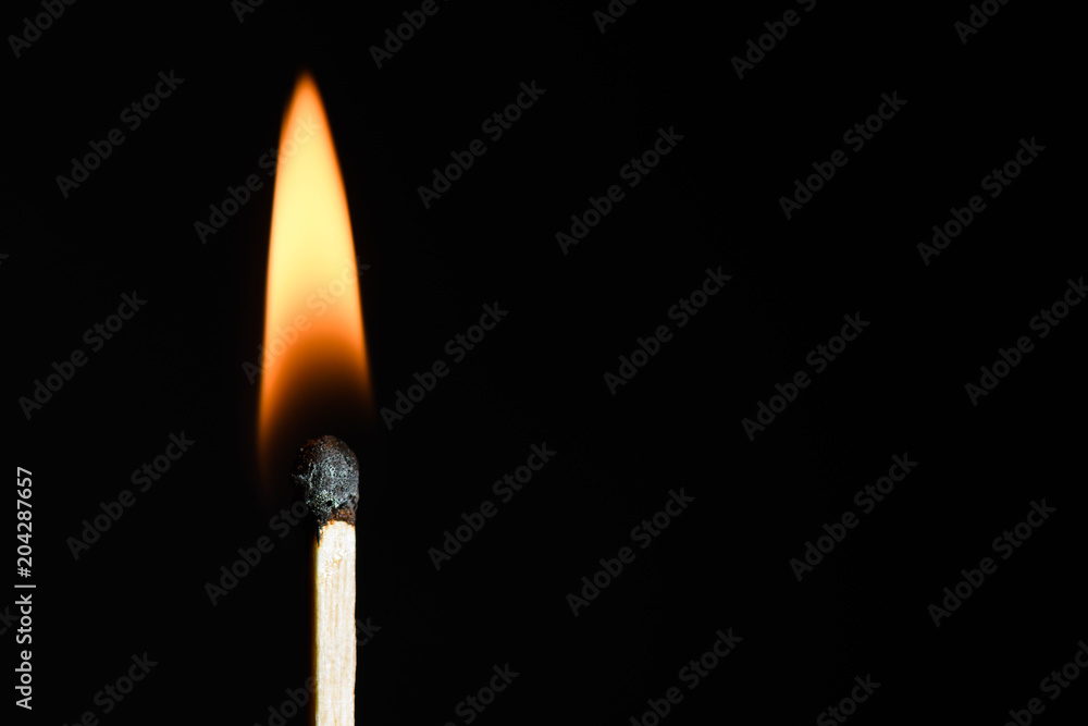 The match on fire on black background close-up The match on fire on black background close-up