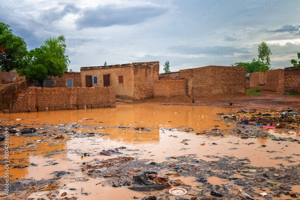 Flooded african slums with lots of garbage during the rainy season (july-august), Ouagadougou, Burkina Faso, West Africa.