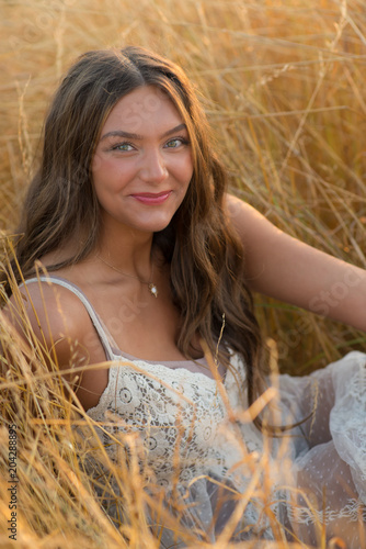 Photography Gorgeous brunette girl laughing in wheat field wearing lacy sundress