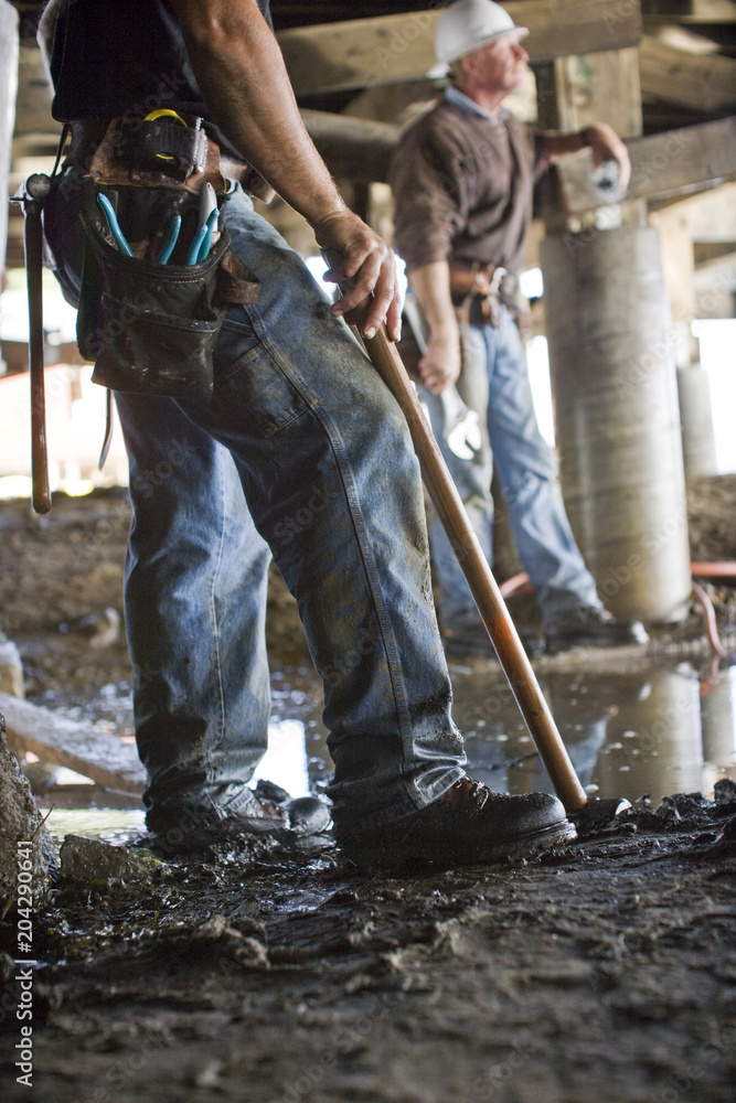 Two male construction workers standing at construction site Two male construction workers standing at construction site