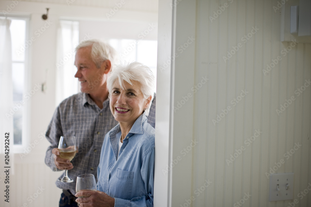 Portrait of a senior woman drinking wine with her husband. Portrait of a senior woman drinking wine with her husband.