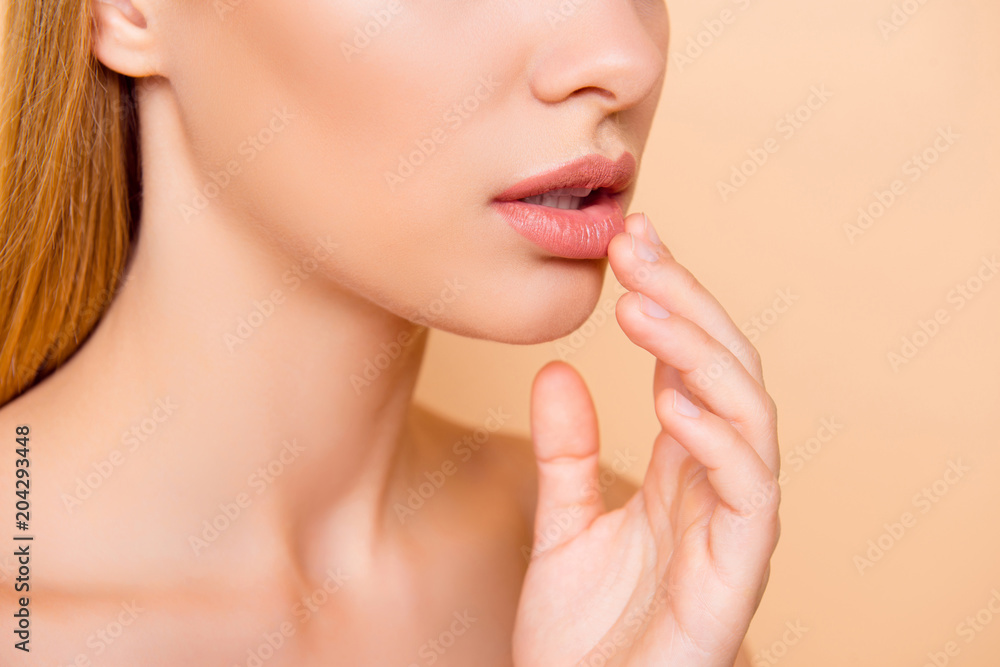 Cropped close up half face portrait of attractive, nude, natural, perfect, ideal girl touching her soft, smooth lips with fingers isolated on beige background, wellness wellbeing perfection concept Cropped close up half face portrait of attractive, nude, natural, perfect, ideal girl touching her soft, smooth lips with fingers isolated on beige background, wellness wellbeing perfection concept