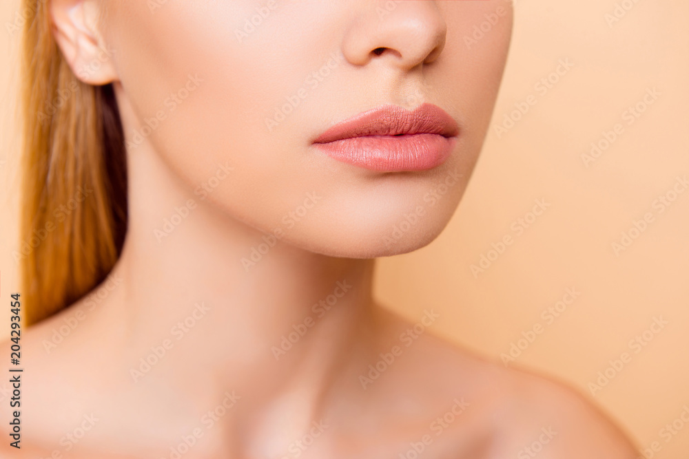 Close up cropped half face portrait of attractive, nude, natural, perfect, ideal girl with soft, healthy smooth lips isolated on beige background, perfection, wellness, wellbeing concept Close up cropped half face portrait of attractive, nude, natural, perfect, ideal girl with soft, healthy smooth lips isolated on beige background, perfection, wellness, wellbeing concept