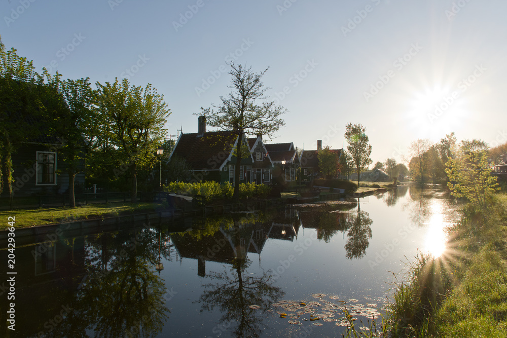 Reflecting sun in a river in Zaanse Schans, The Netherlands