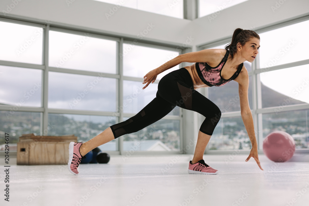 Female doing stretching workout in health center Female doing stretching workout in health center