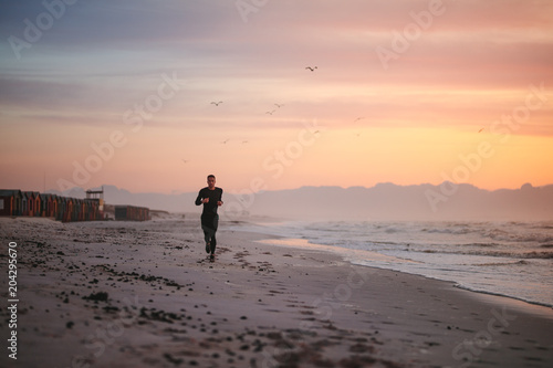 Fit male runner running on the beach