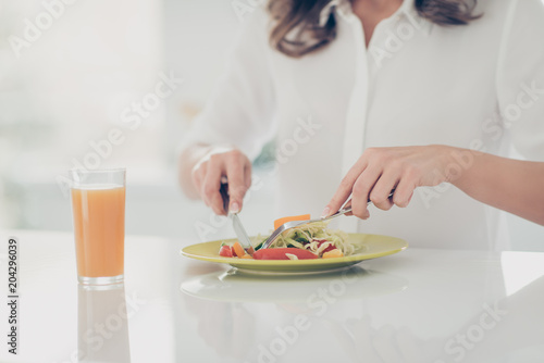 Cropped portrait of woman's hands eating fitness salad from dish with cutlery having fresh drink eating healthy cuisine keeping weight loss program, cook, cookery concept