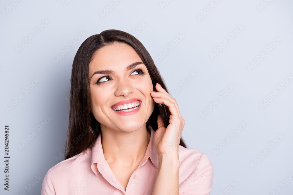 Portrait of cheerful, positive, glad, charming, pretty, brunette woman having funny, comic conversation on smart phone, cellphone, enjoying talking with friend, isolated on grey background Portrait of cheerful, positive, glad, charming, pretty, brunette woman having funny, comic conversation on smart phone, cellphone, enjoying talking with friend, isolated on grey background