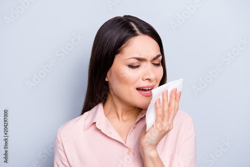 Obraz na plátne Portrait of ill, sick woman feeling bad, unwell, sneezing in napkin in her hand