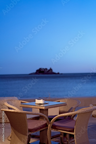 Restaurant table at a seaside resort at dusk