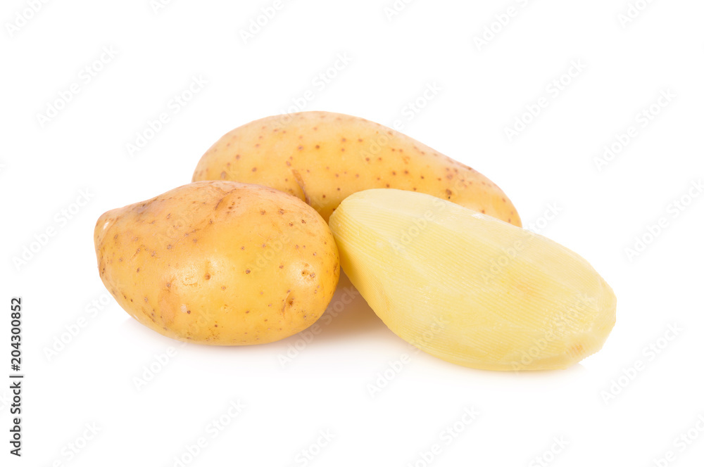whole and peeled fresh potatoes on white background