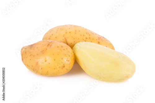 whole and peeled fresh potatoes on white background