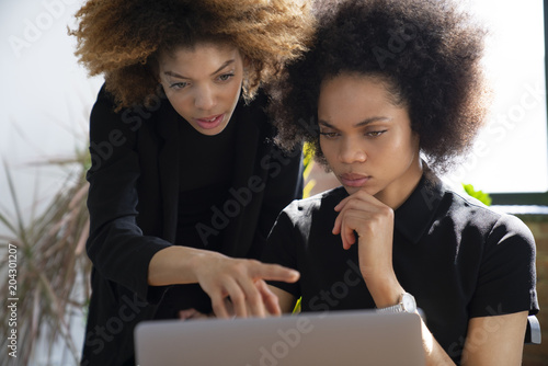 Businesswomen using laptop while sitting in office