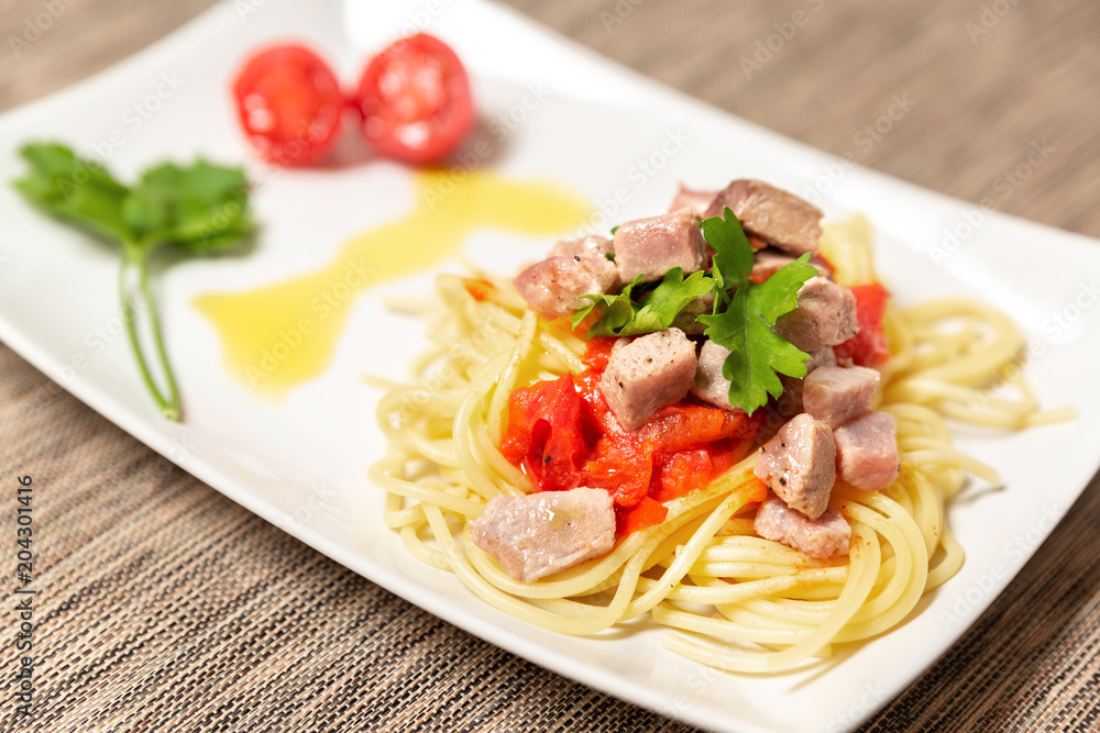 Spaghetti with sauce of Mediterranean tuna, Italian extra virgin olive oil, pepper, cherry tomatoes and a sprinkling of parsley Spaghetti with sauce of Mediterranean tuna, Italian extra virgin olive oil, pepper, cherry tomatoes and a sprinkling of parsley