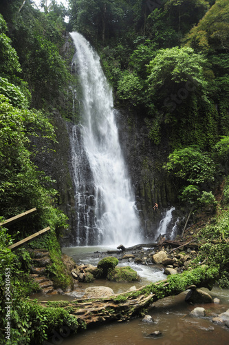 A man sits beside Catarata Zamora, one of two impressive waterfalls in Los Chorros park in Costa Rica.