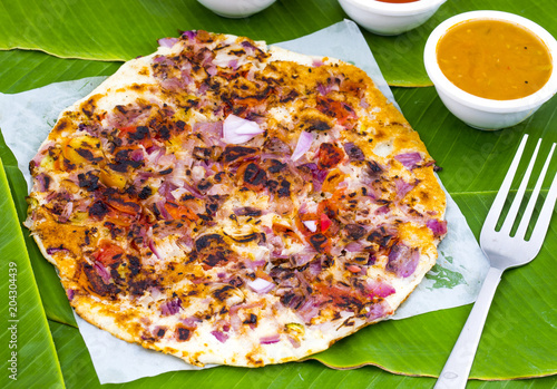 South Indian Food Uttapam Also Know As ooththappam, Rava Uttapam, Uttapa or Uthappa is a Popular South Indian Delicious Spicy Breakfast Snack Served with Coconut Chutney, Tomato Sauce and Sambar photo