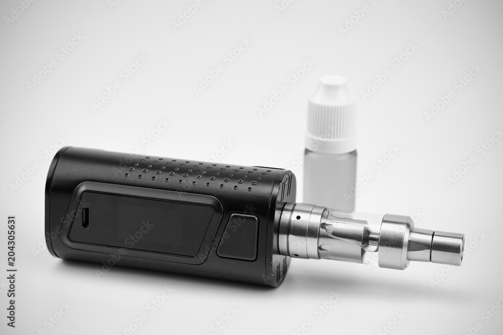 E - cigarette for vaping , technical devices.The liquid in the bottle E - cigarette for vaping , technical devices.The liquid in the bottle
