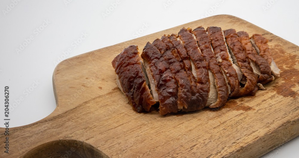 Roasted duck on wooden cutting board isolated on white Roasted duck on wooden cutting board isolated on white