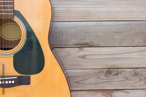 Acoustic guitar on wood desk background