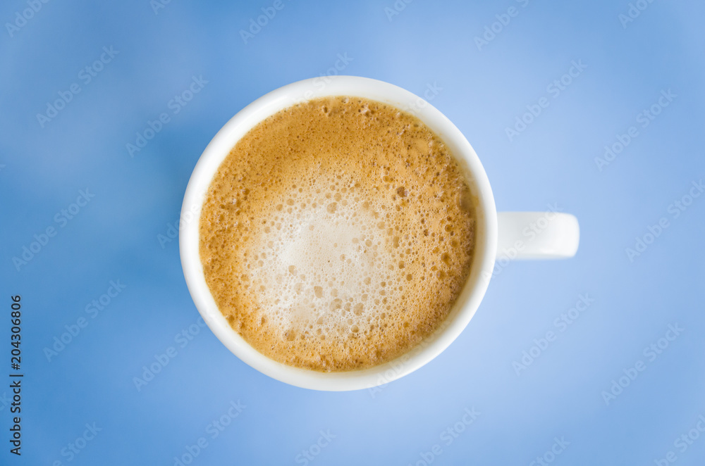 White cup of coffee on light blue background. White cup of coffee on light blue background.