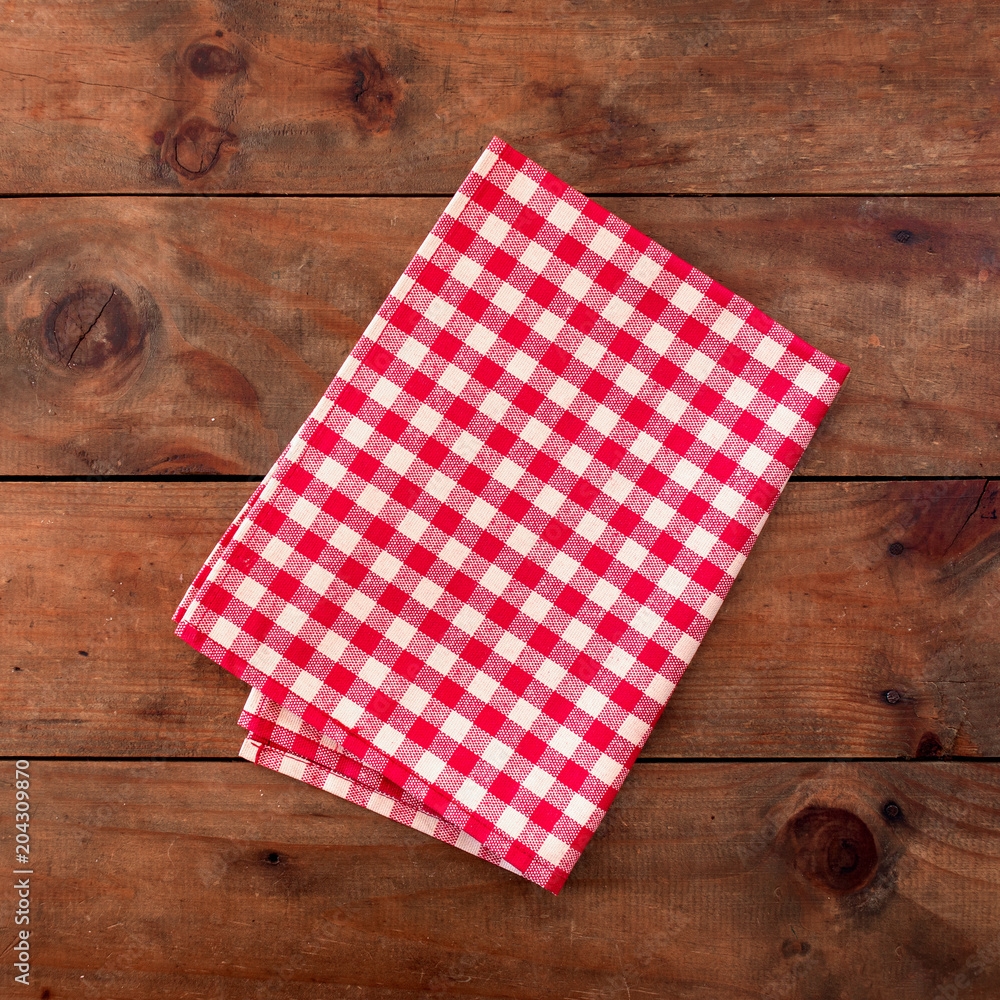 Red classic Checkered tablecloth on wooden table, background with copy space Red classic Checkered tablecloth on wooden table, background with copy space