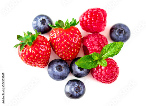 Fototapeta Naklejka Na Ścianę i Meble -  Sweet berries mix isolated on white background. Heap  of Ripe raspberry, strawberry  and blueberries, mint leaf. Macro, top view