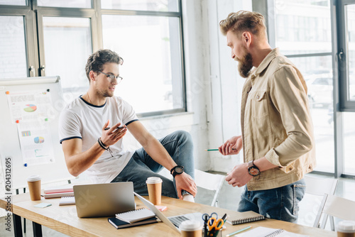 Successful managers discussing business results in modern light office