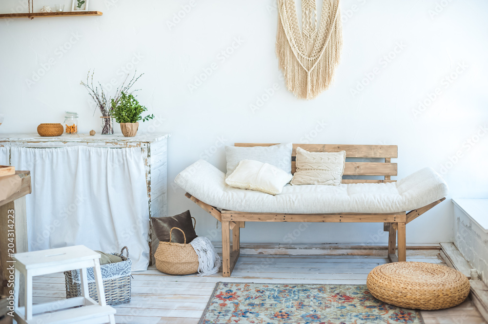 Obraz premium Kitchen in rustic style in summer. Spring light textured kitchen with an old fridge, wooden table. Beautiful eco-friendly wooden sofa