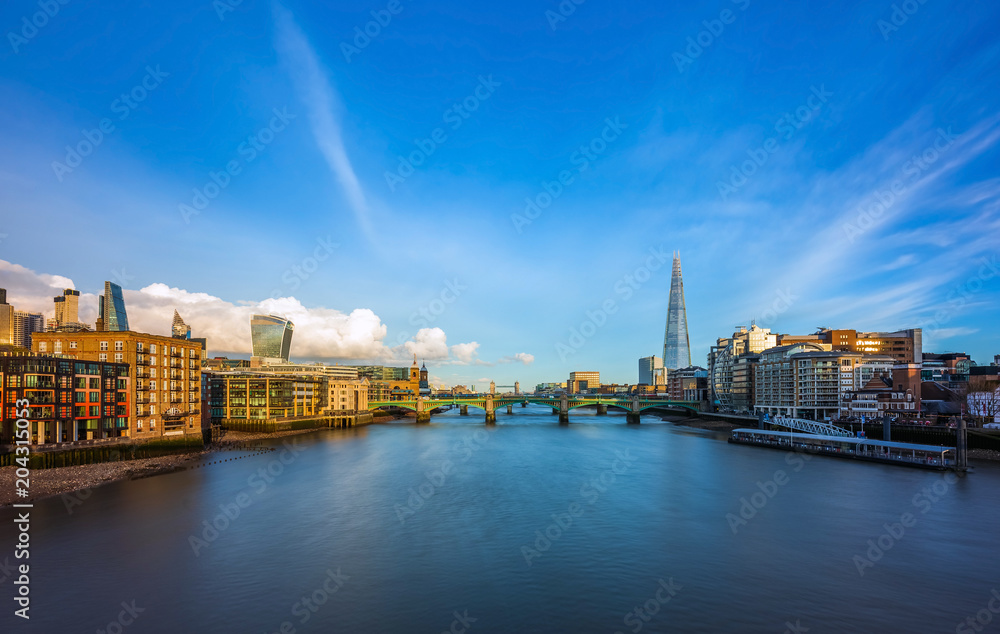 Naklejka premium London, England - Panoramic skyline view of central London with skyscrapers of Bank district, River Thames, Tower Bridge and other famous landmarks at sunset