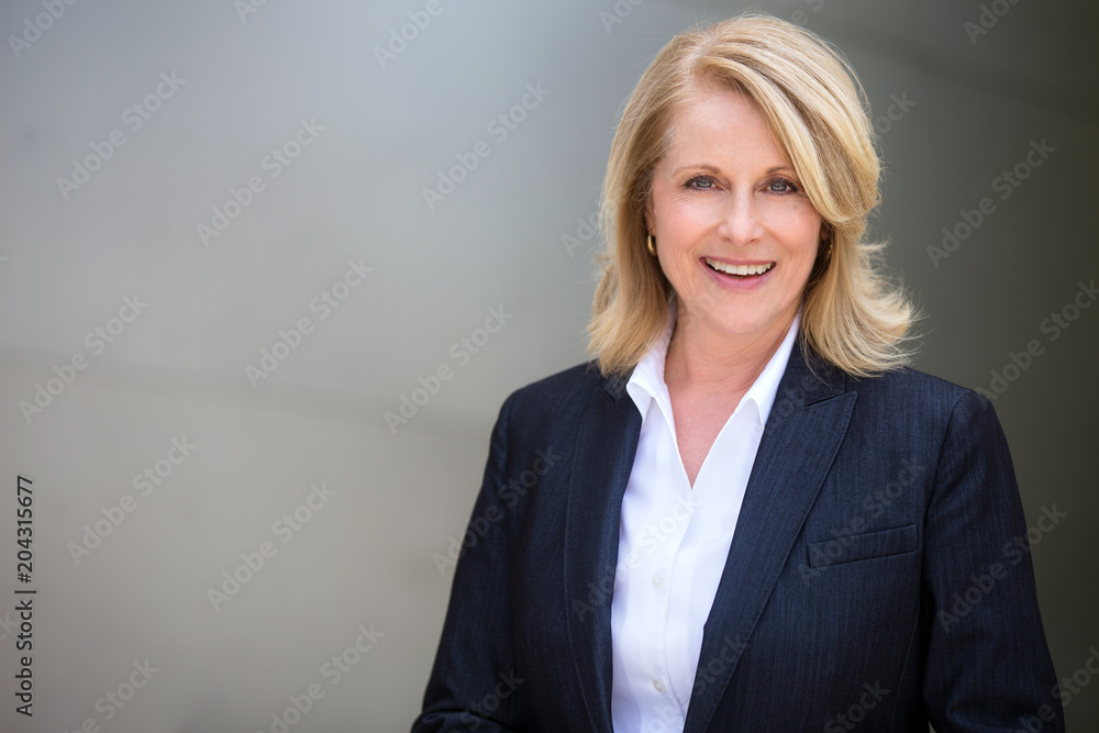 Classy distinguished blonde business woman professional executive attorney  in a modern suit Stock Photo
