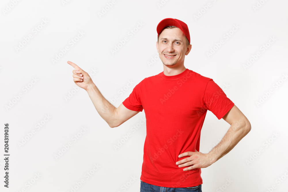 Delivery man in red uniform isolated on white background. Professional smiling male in cap, t-shirt working as courier or dealer, pointing index fingers aside gesture. Copy space for advertisement. Delivery man in red uniform isolated on white background. Professional smiling male in cap, t-shirt working as courier or dealer, pointing index fingers aside gesture. Copy space for advertisement.