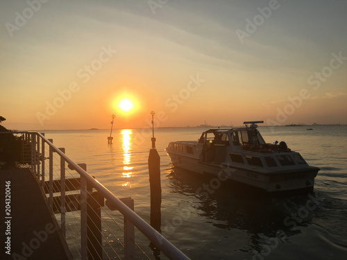 The Shuttle boat near the pier during the sunset in Venice