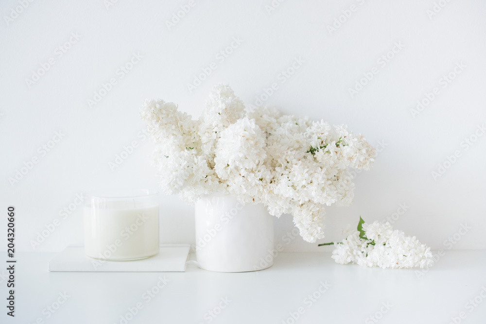 Minimalist white home decor, fresh lilac flowers bouquet in vase