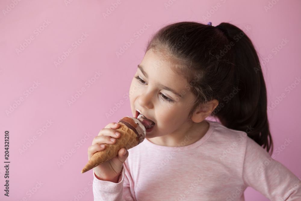 happy little girl with ice cream on a pastel background happy little girl with ice cream on a pastel background