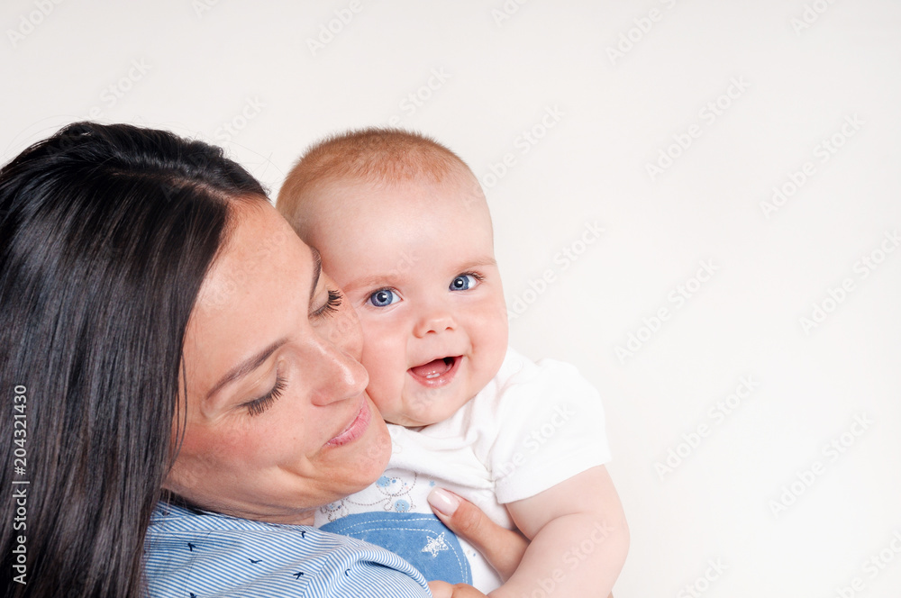 Portrait of a happy young mother near cute baby Portrait of a happy young mother near cute baby