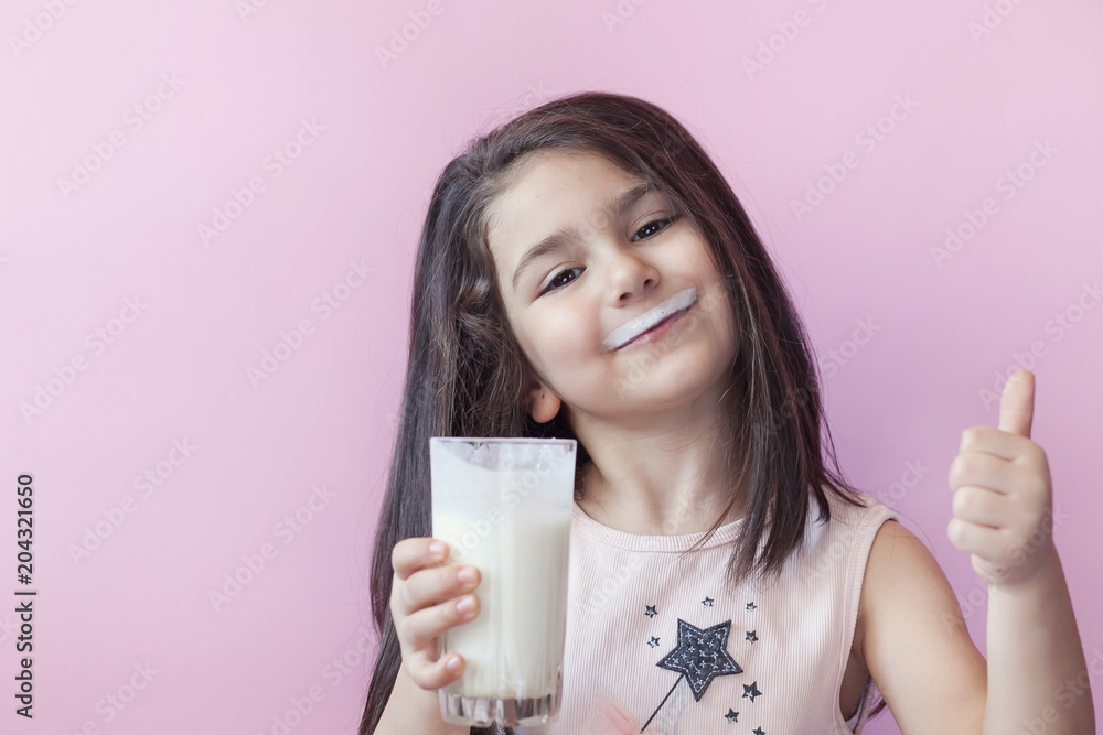 Happy child girl drinking yogurt. Whiskers from yogurt Happy child girl drinking yogurt. Whiskers from yogurt