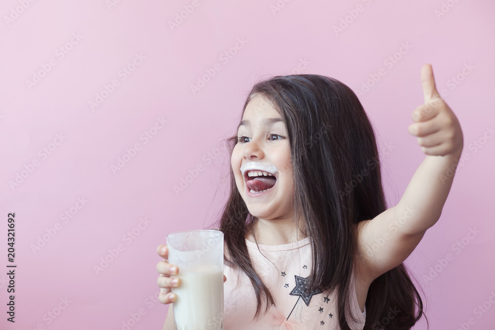 Happy child girl drinking yogurt. Whiskers from yogurt Happy child girl drinking yogurt. Whiskers from yogurt